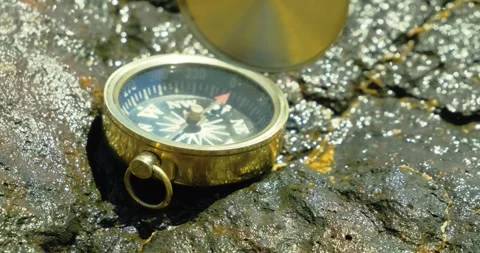 Compass on Rocky Surface in Sunlight Exploration Stock Footage 323570031