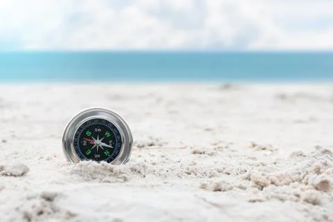 Compass on sand beach. Stock Photos
