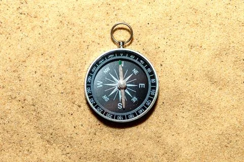 Compass on the sand at the beach Stock Photos