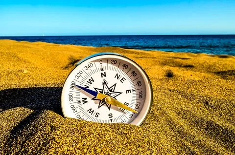 Compass on the Sand Beach Stock Photos