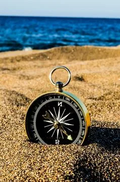 Compass on the Sand Beach Stock Photos