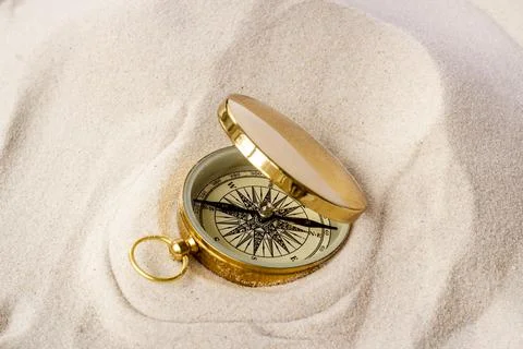 Compass in the sand. Best solution or direction concept Photos