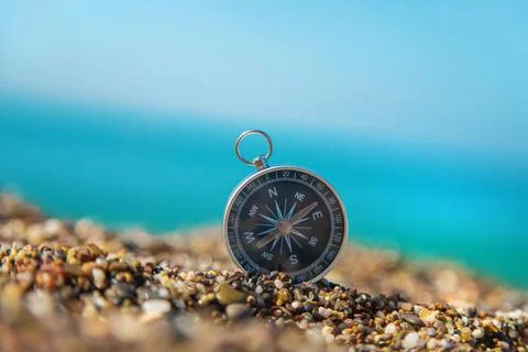 Compass on the sea beach. Selective focus. Stock Photos