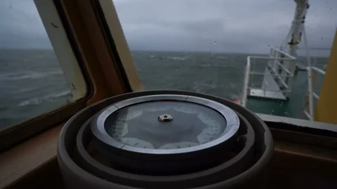 Compass on the ship. Storm. Close-up. Splashes of waves on the glass. View of Stock Footage 151357617