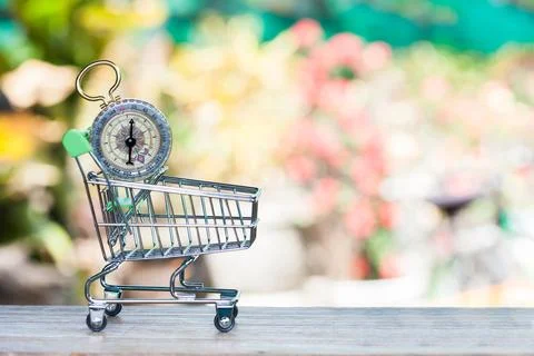 Compass in shopping cart Stock Photos