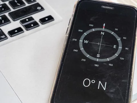 A compass on a smart phone indicates zero degrees North. Stock Photos