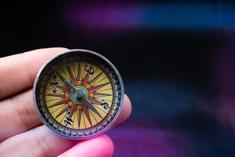 Compass tool in hand on black Stock Photos