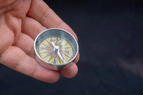 Compass tool in hand on black Stock Photos