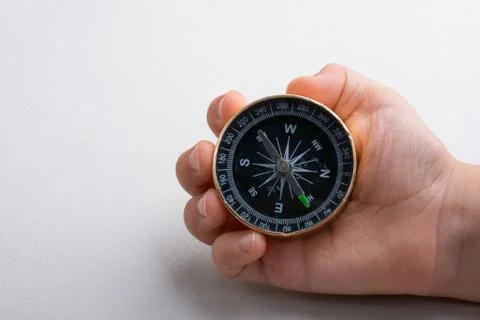 Compass tool in hand on white Stock Photos