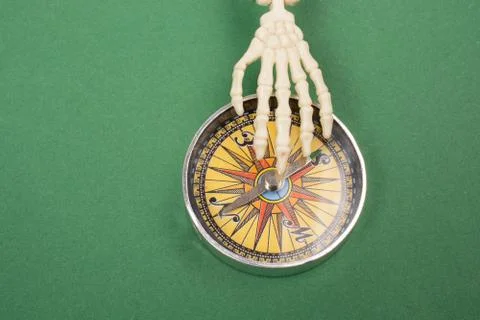 Compass tool with a skeleton hand on it Stock Photos