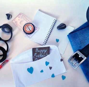 Compass, tools on white background and postcard to the day of the father Stock Photos
