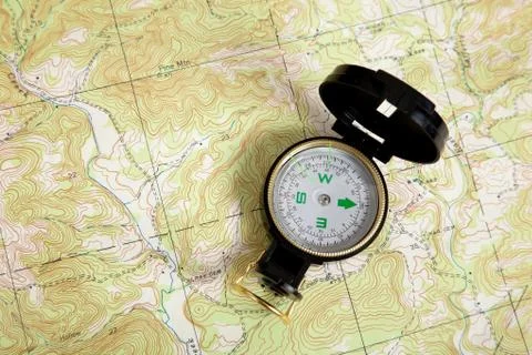 Compass on a topographical map Stock Photos