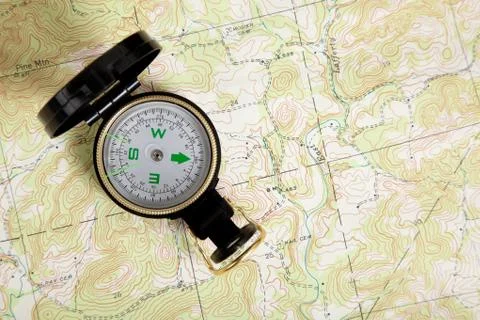 Compass on a topographical map Stock Photos