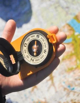 Compass under the sun on the palm Stock Photos