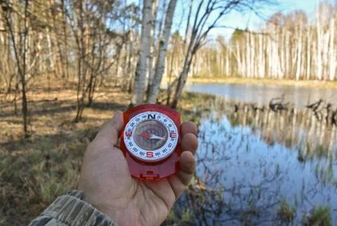 With compass on the walk. Stock Photos