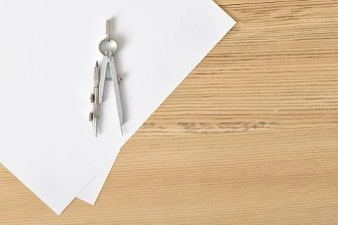Compass on white paper in top view with copy space Stock Photos