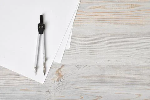 Compass on white paper in top view with copy space Stock Photos