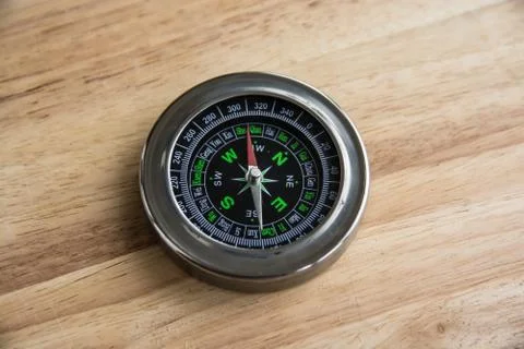 Compass on a wooden surface. Stock Photos