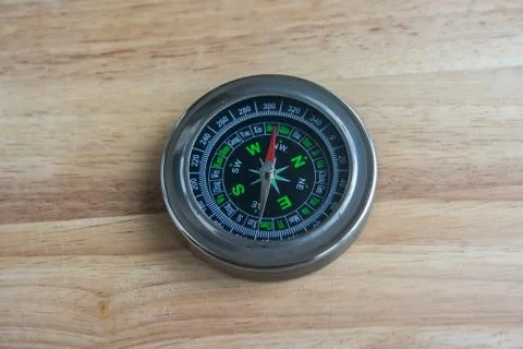Compass on a wooden surface. Stock Photos