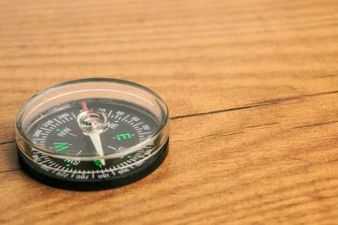 Compass on a wooden table Stock Photos