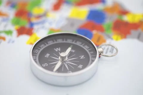 Compass with world map in background Foto stock