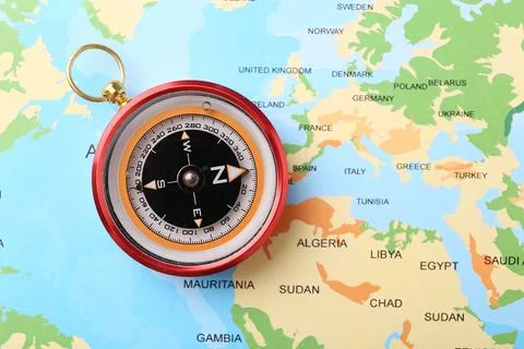 Compass on world map, top view. Navigation equipment Stock Photos