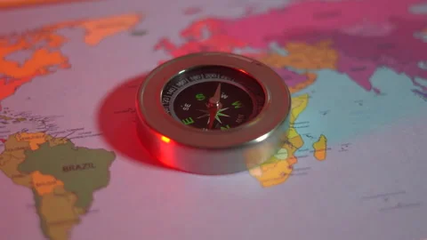 Compass on the world map under the red light Stock Footage 305001017
