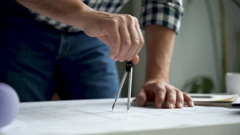 The compasses in the hands of an engineer. Architect working on blueprint Video stock 231484724