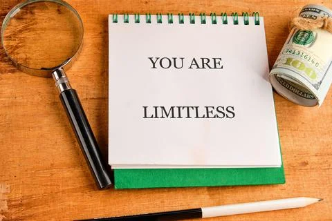 A compelling declaration YOU ARE LIMITLESS illuminates a white notepad, accom 库存照片