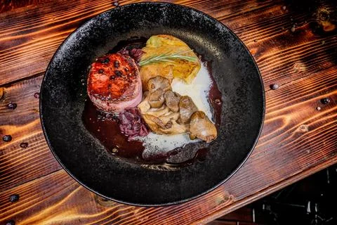 A compelling overhead angle of a restaurant meal: A steak, mushroom and potat Stock Photos