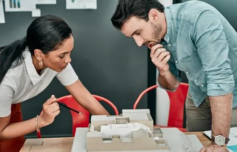 Competent and creative is exactly what they are. two architects working together Stock Photos