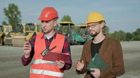 Competent builder controlling work at construction site outside Foto stock