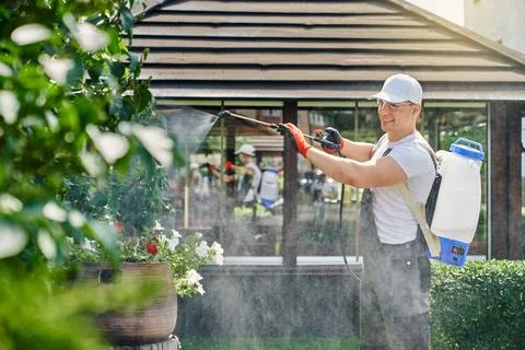 Competent gardner in protective clothes Stock Photos