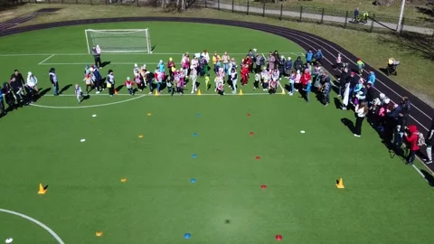 Competition of children's mixed relay teams at the school stadium Stock Footage 188759502