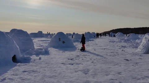 Competition for the construction of an igloo from snow bricks Stock Footage 302732959
