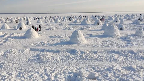 Competition for the construction of an igloo from snow bricks Stock Footage 302733009