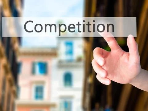 Competition - Hand pressing a button on blurred background concept on visual  Stock Photos