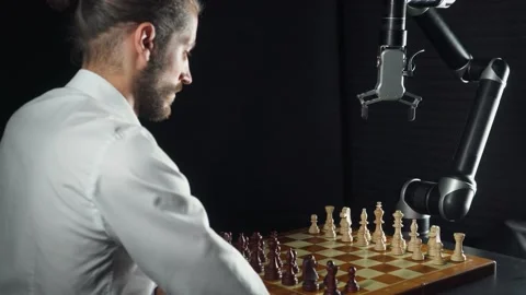 Competition, man playing chess with a robot, the confrontation between man  Stock Footage 133221209