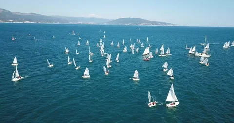 Competition on small yachts under sail on the Black Sea in Novorossiysk. Aerial Stock Footage 121487849
