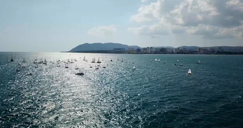 Competition on small yachts under sail on the Black Sea in Novorossiysk. Aerial Stock Footage 121487864
