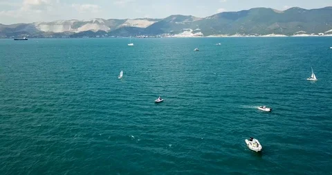 Competition on small yachts under sail on the Black Sea in Novorossiysk. Aerial Stock Footage 121487925