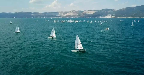 Competition on small yachts under sail on the Black Sea in Novorossiysk. Aerial Stock Footage 121487965