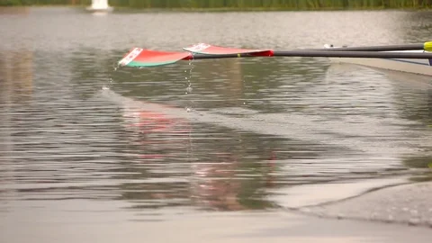 Competitions in rowing. Paddle in the water. Water splashes. Slow motion. Video stock 77145963