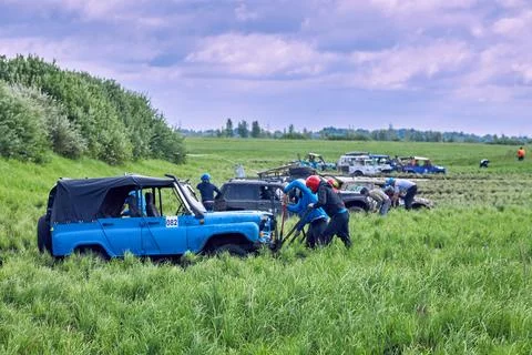 Competitions taking place in difficult terrain on 4x4 off-road vehicles Stock Photos