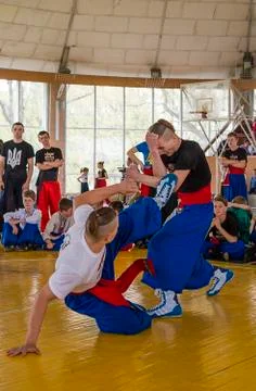 Competitor kicked protected from opponent Stock Photos