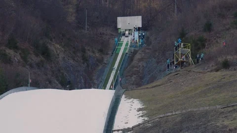 Competitor sliding down on a curved ram on ski jumping venue Stock Footage 170433445