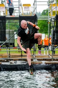 A competitor taking part in a Tough Mudder extreme sport event at Drumlanrig  Stock Photos