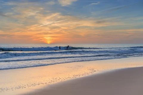 Competitors practiced surfers at sunset. Stock Photos