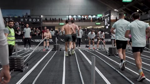 Competitors Running Back to Pull Weighted Sled Stock Footage 336660280