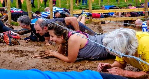 Competitors taking part in a Tough Mudder extreme sport event at Drumlanrig C Stock Photos